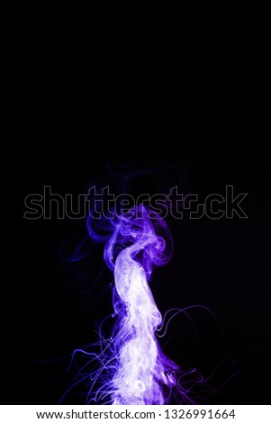 Column of vape clouds splash on black background. A lot of lines of smoke. Two colours fog is blue and purple. Stock isolated color smoke with spray boiling liquid.