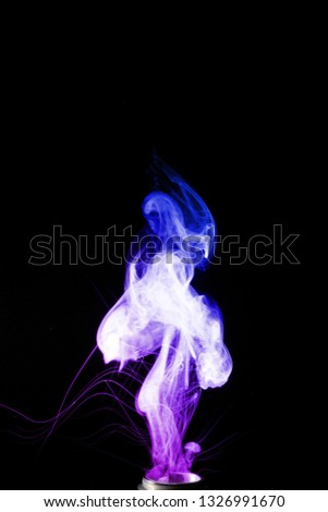 Colored clouds of vape smoke. A lot of colour and glicerine clouds, red and blue colours. Stock photo isolated on black background with boling spray of vaping liquid. Vape culture and no smoking