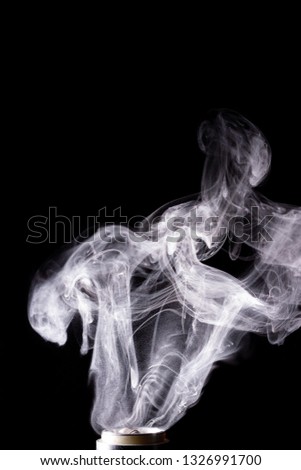 Vape clouds splash on black background. Stock isolated white smoke with spray boiling glycerine.