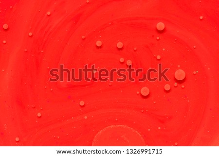Red paint background in concept power texture. Colors dropped into liquid and photographed while in motion. abstract composition.