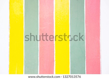 soft yellow and pink pastel color paper stripes flat lay background.