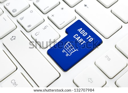 Shop on line add to cart business concept, Blue shopping cart button or key on white keyboard photography.