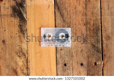 Vintage cassette tape on timber background awesome mix playlist demo 80s 90s love mixtape hip hop case
