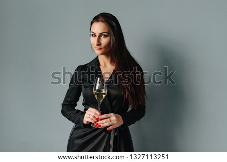Picture of romantic lady celebrate 8 March. Spring time and good wine. Beautiful woman in black dress. Sweet Wine. Romantic day. Copy space.