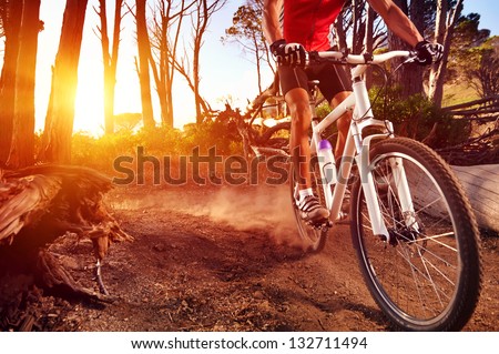 Mountain Bike cyclist riding single track at sunrise healthy lifestyle active athlete doing sport Royalty-Free Stock Photo #132711494