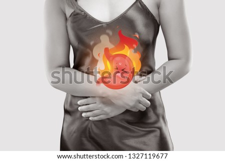 The photo of cartoon stomach on woman's body against a gray background, Gastroesophageal reflux disease, Acid reflux disease symptoms or heartburn, Concept with healthcare and medicine