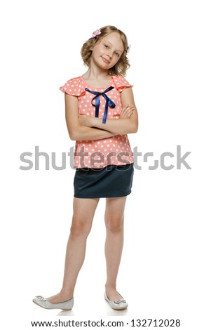 Little girl standing with folded hands in full length, over white background