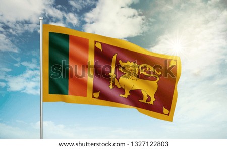 Sri Lanka flag 2 waving in the wind against a blue sky and clouds