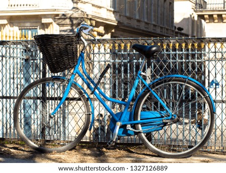 blue bicycle at the fence
