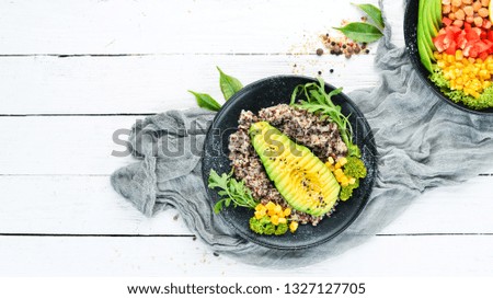 Boiled quinoa with avocado and vegetables. Top view. Free space for your text.