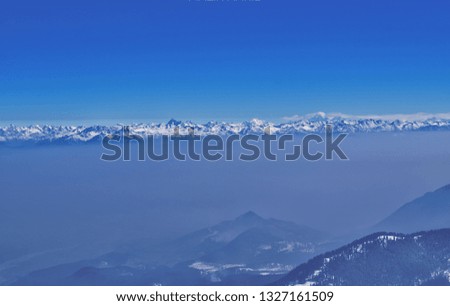 Himalayan moutains covered with snow taken from helicopter. Drone shot of mountains. clear sky. climate change concept.