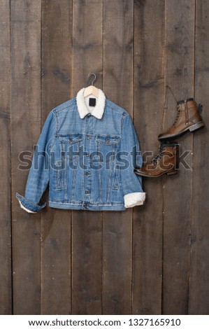 jeans jacket with boots on a wooden background
