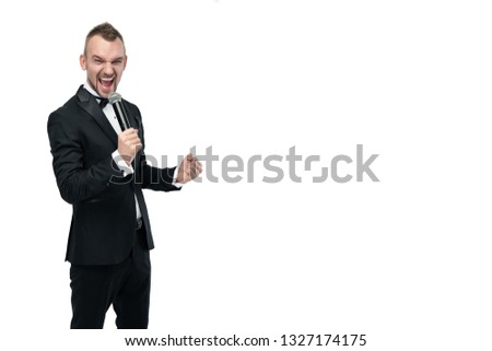 young presenter in a black tuxedo with a microphone on a white background