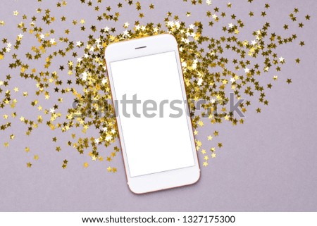 Mobile phone with golden stars confetti on pink color paper background minimal style, color of 2021 year Ultimate Gray  and Illuminating