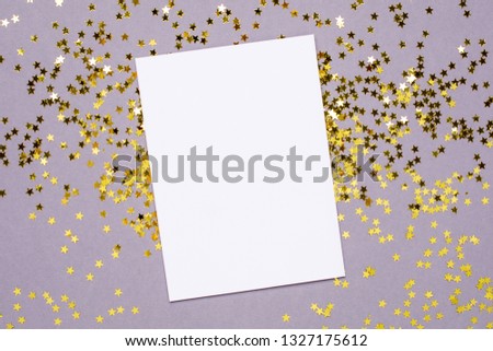 Golden stars confetti and white card on gray color paper background minimal style, color of 2021 year Ultimate Gray  and Illuminating
