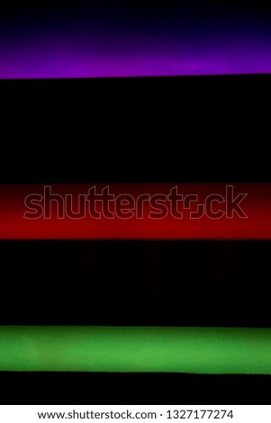 Multicolor neon color lights on black background. Place for text.