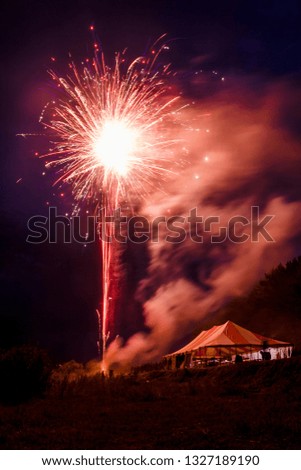 populous festive multi colour fireworks outside the city in the summer camp on isolated background of the night black sky