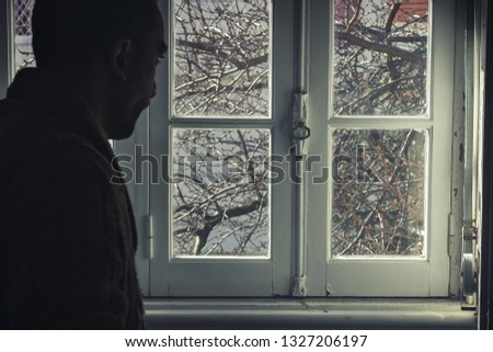 A man looking, interior home, vintage window
