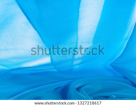 texture background pattern. blue silk fabric This is a light artificial silk fabric of dupioni with a subtle matte sheen. It is perfect for your design, accents, wallpapers, posters and cards.