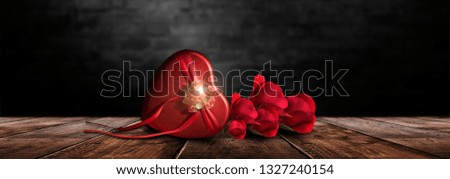Romantic background with flowers, red roses and a box, a heart-shaped box. Night lanterns, the magical atmosphere of the evening. The scenery is romance. Love stories for women. Night view.