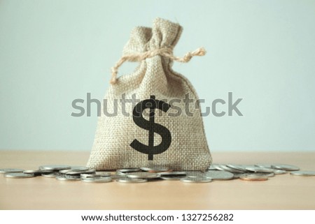 Money bag with coins on table,saving money for loan with working capital management concept.