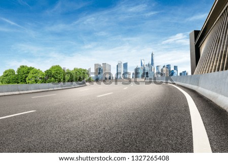 Asphalt road and modern city commercial building scenery in Shanghai