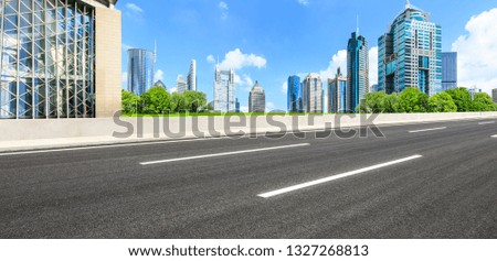 Asphalt road and modern city commercial building scenery in Shanghai