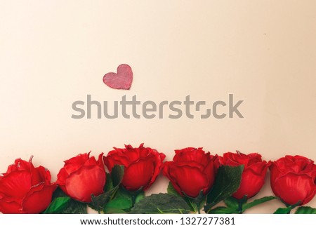 beautiful roses flowers and wooden heart isolated on pink background