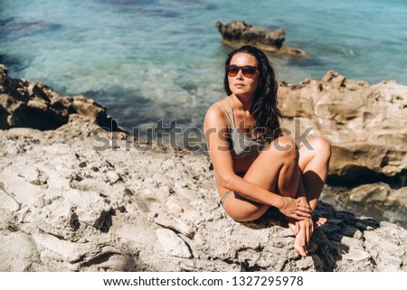 Pretty pan asian girl relaxing outdoor on the beach at the sea
