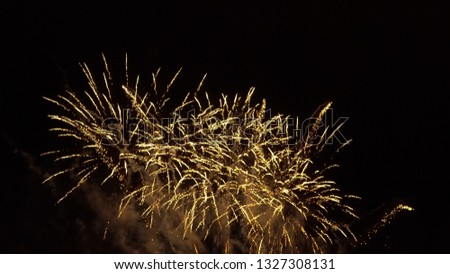 Golden fireworks at night. The picture for a greeting card template with a black background. The spectacular, festive firecracker. 