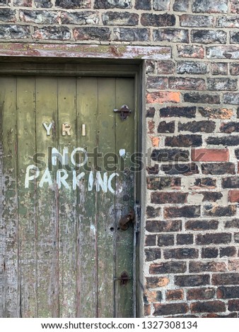 This fabulous faded green wooden door was behind the railway station in York in North Yorkshire, love the no parking sign written on the wooden door which is old and the paints peeling away