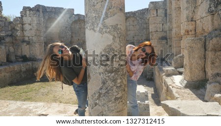 Tourists look out the ancient column in ancient city open air museum