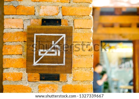 No smoking sign on the brick wall