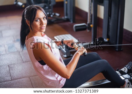 Young fitness woman working out in the gym