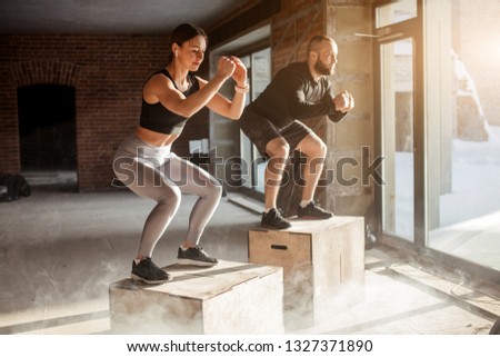 Handsome active caucasian couple, happy as family, successful as partners, determined as sports people, engaged in crossfit training. Royalty-Free Stock Photo #1327371890