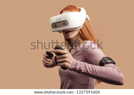 Emotional female with red long hair standing experiencing vertual reality headset for the first time. Generation of realistic images of alternative digital reality
