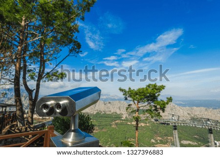 Closeup view of coin operated binocular viewer for looking in details at beautiful summer sea landscape. Antalya, Turkey. Happy summer holidays and sightseeing concept. Horizontal photography.