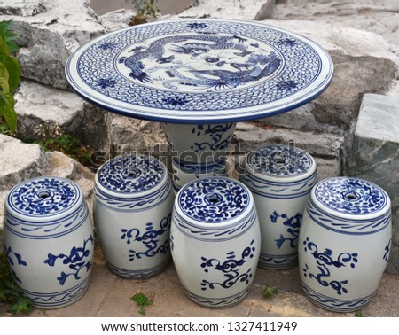 Antique china ceramic bench and table with traditional blue design in garden