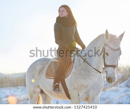 young woman walking with a horse
