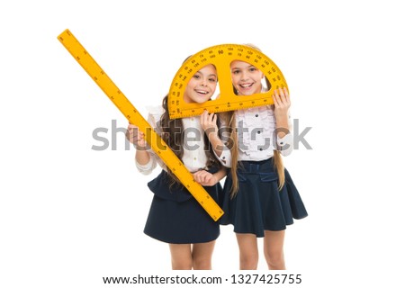 Having fun in school. Pupil cute girls with big rulers. School children with measuring instruments. Geometry favorite subject. Education and school concept. School students learning geometry.