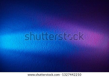 White ray of light and pink blurred glow on the blue textural background