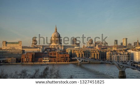 St. Paul’s Cathedral and the millennium bridge over the River Thames with afternoon sun