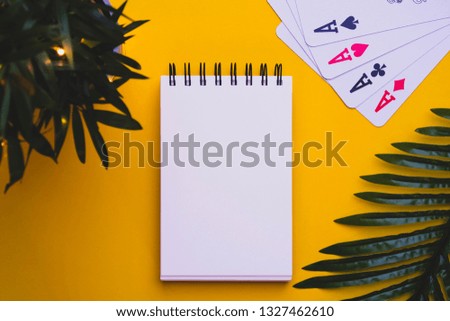 Yellow background with plants and cards and blank space