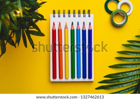 Yellow background with plants and planner supplies 