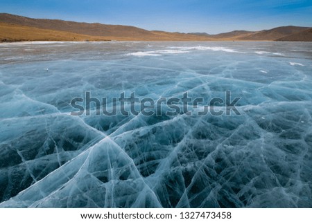 Frozen ice field of lake Baikal in winter