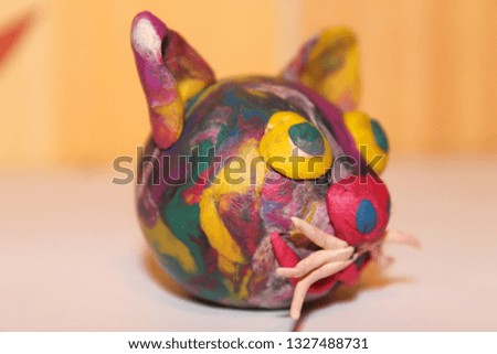 multi-colored plasticine cat head close-up. creativity and design.