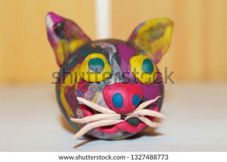 multi-colored plasticine cat head close-up. creativity and design.