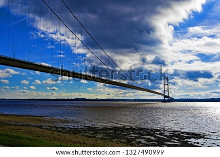 Taken to capture the Humber Bridge and the Humberside Estuary, on a bright sunny day, in March 2019.  Royalty-Free Stock Photo #1327490999