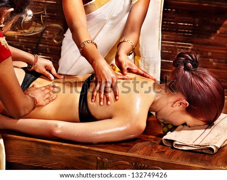 Young woman having oil Ayurveda spa treatment.