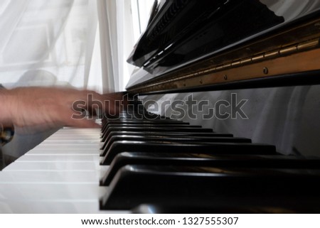 Hands playing piano while moving move effect close up 